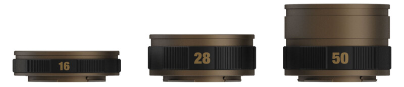 Three camera lenses placed side by side, arranged by size from left to right: a 16mm wide-angle lens, a 28mm medium lens, and a 50mm standard lens. All lenses are in a brownish metallic finish with black focusing rings and yellow focal length numbers.