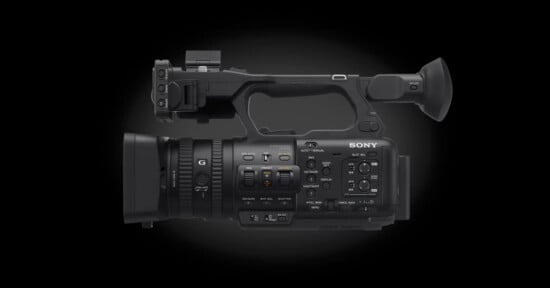 A black Sony professional video camera placed against a dark gradient background. The camera features various buttons, dials, and a viewfinder, indicating its advanced functionality. The brand name "Sony" is visible on the camera body.