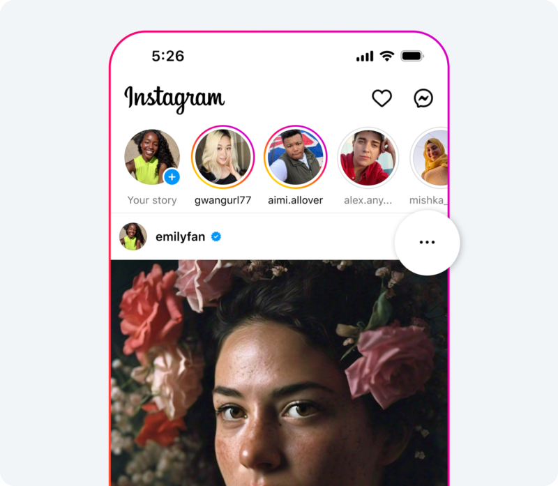 A smartphone screen showing the Instagram app open. At the top, there are circular profile pictures with colorful rings indicating active stories. Below, a post by "emilyfan" features a portrait of a person with flowers in their hair. The time is 5:26.