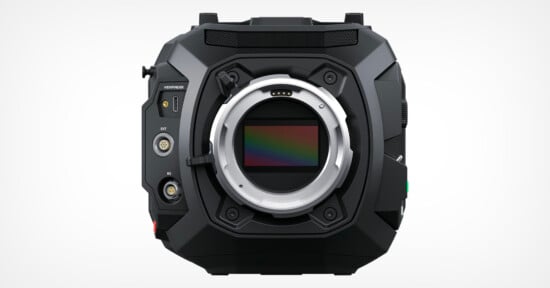 A black cinema camera body with no lens attached, showing the sensor and various ports on the left side labeled "SDI" and "IN." The camera has a rugged, angular design and displays the word "VENICE" near the top left corner. The background is plain white.