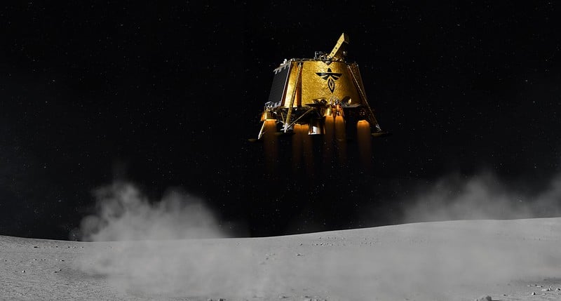 A golden spacecraft hovers just above a gray, dusty lunar surface. It emits thrust from its engines, creating a cloud of dust below. The blackness of space serves as the backdrop, peppered with faint stars.