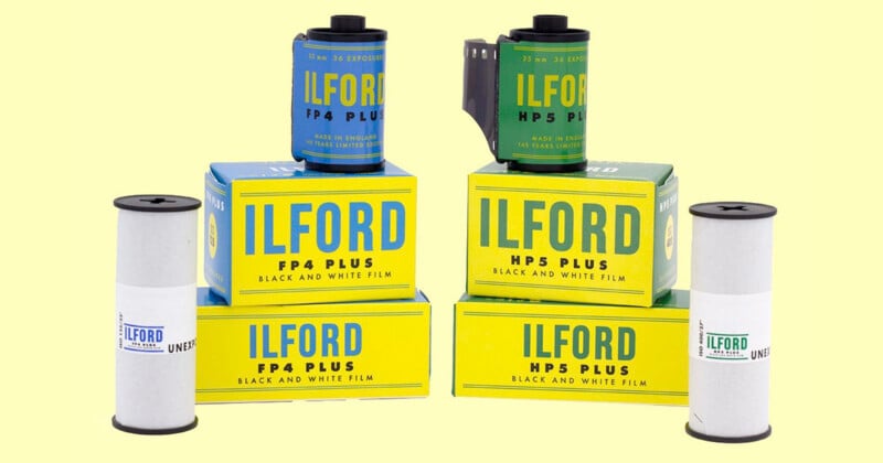 The image shows several boxes and rolls of ILFORD black and white film. The boxes are labeled "HP5 Plus" and "FP4 Plus" and are yellow with blue and black text. Four film canisters are positioned around the boxes, two of which are in gray film canisters.