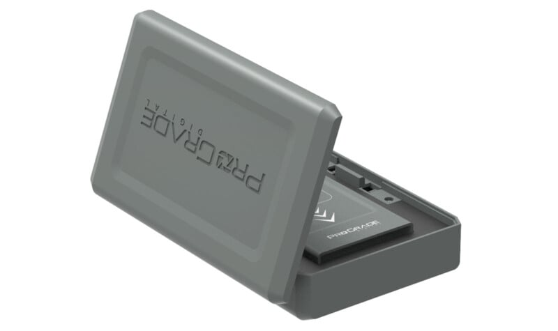 A gray ProGrade Digital memory card case with its lid open, showing slots and one visible memory card inside. The case features a minimalist design with the ProGrade Digital branding embossed on the lid.