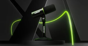 A black Shure microphone with a stand is positioned on a circular platform against a sleek, dark background. Bright green lines accent the scene, adding a modern touch. The microphone appears to be a dynamic or podcasting model.