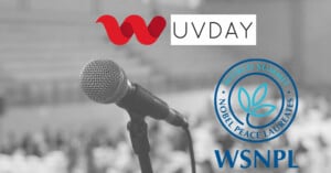 A close-up of a microphone in the foreground with a blurred audience in the background. At the top left is the UV Day logo, and at the bottom left is the World Summit of Nobel Peace Laureates (WSNPL) logo.