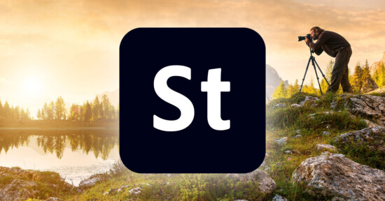 A serene landscape at sunrise with a lake surrounded by trees and mountains in the background. A photographer is capturing the scene with a camera on a tripod. In the foreground, the Adobe Stock logo (a black square with "St" in white) is prominently displayed.