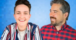 Two people are smiling against a blue pixelated background. The person on the left has short dark hair and is wearing a striped shirt. The person on the right has dark hair and a beard, wearing a red and blue plaid shirt, and is looking at the person on the left.