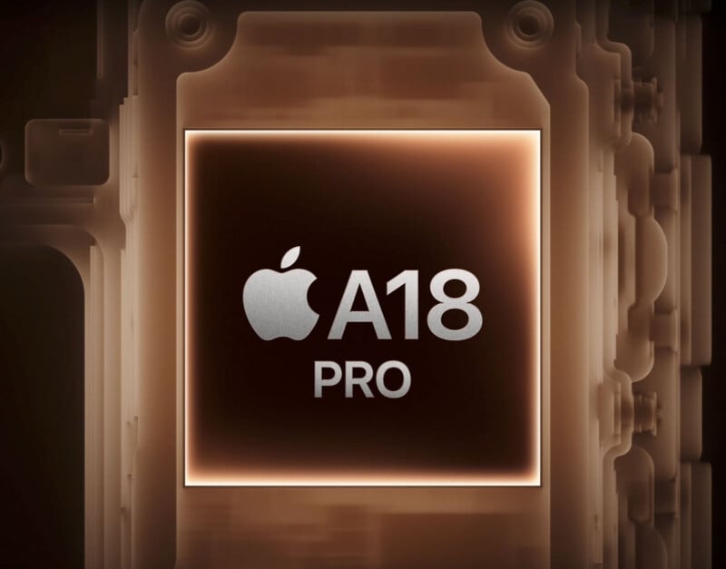 Image of a metallic, square-shaped microchip with the Apple logo and the text "A18 PRO" in the center. The background is a complex array of circuit-like patterns, giving the image a high-tech, futuristic feel.