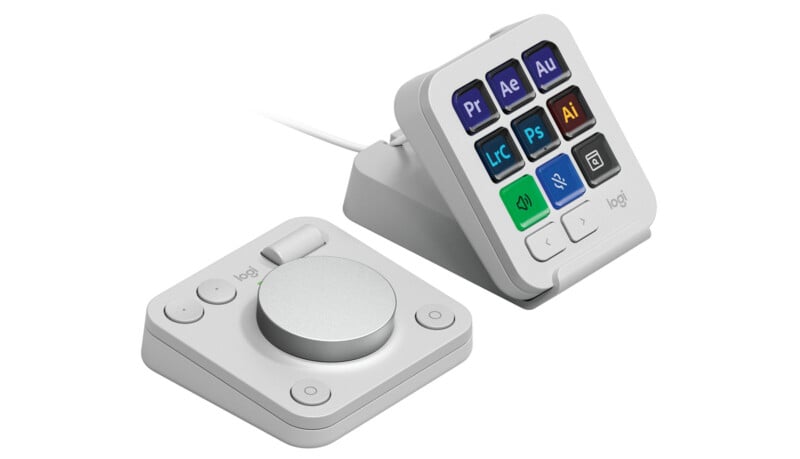 A sleek white Logitech controller set consisting of a dial and button pad. The button pad features customizable buttons with icons for popular applications like Adobe Premiere, After Effects, and Photoshop, arranged on a connected stand.