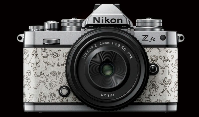 A Nikon Z fc camera with a vintage design is adorned with whimsical cartoon illustrations of people in various poses. The front features a Nikkor Z 28mm f/2.8 SE lens. The illustrations add a unique and playful element to the otherwise classic camera.