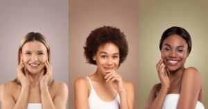 Three women of diverse backgrounds smile and touch their faces in side-by-side portraits with gradient backgrounds. The first woman has straight blonde hair, the second woman has a curly afro, and the third woman has straight dark hair.