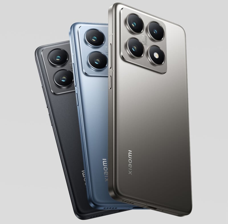 Three smartphones are displayed in a staggered arrangement, featuring metallic finishes in black, blue, and silver. Each phone has a prominent triple-camera module on the back and displays the "Xiaomi" brand name on the lower back.