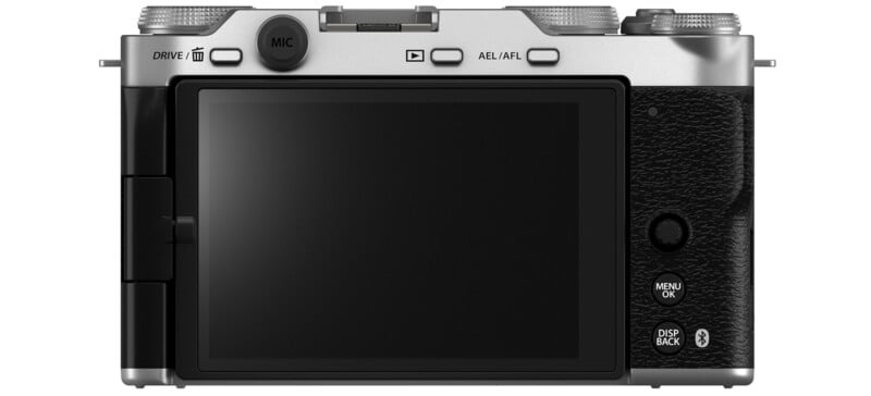 Rear view of a digital camera showing the LCD screen and various buttons. The body is silver with a textured black grip, featuring controls labeled "MIC," "AEL/AFL," "MENU/OK," and "DISP BACK." The DRIVE and Bluetooth symbols are also visible.