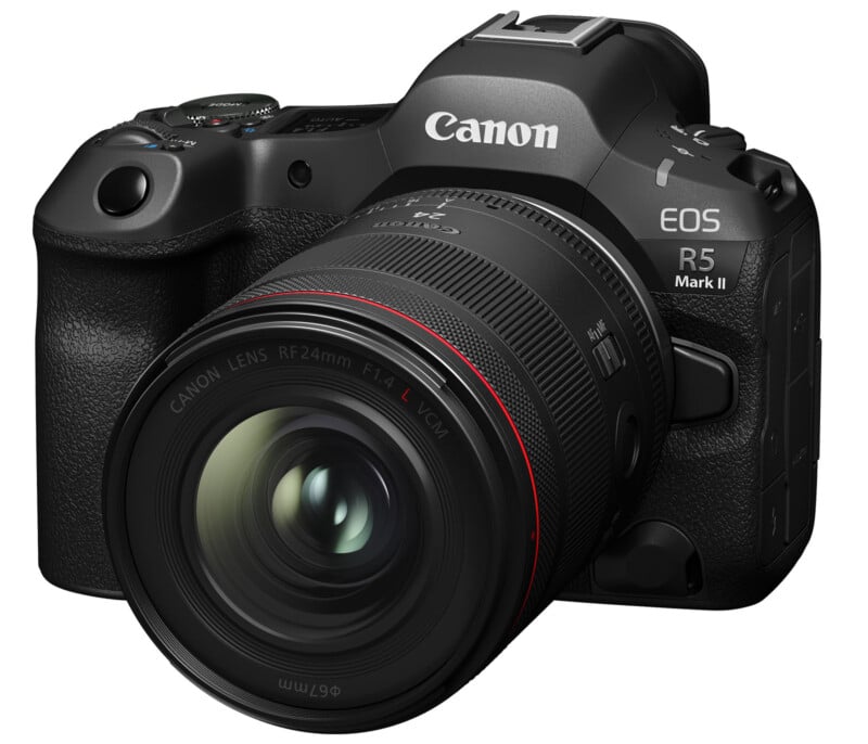 A black Canon EOS R5 Mark II camera with a large lens attached. The camera has a textured grip and visible brand markings.