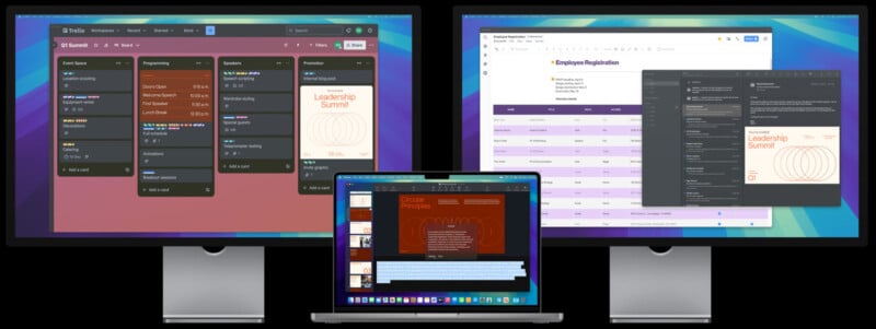 Two large monitors and a laptop display digital project management tools. The screens show Trello boards, Google Sheets, and a design layout for a Leadership Summit, indicating a focus on event planning and management tasks.