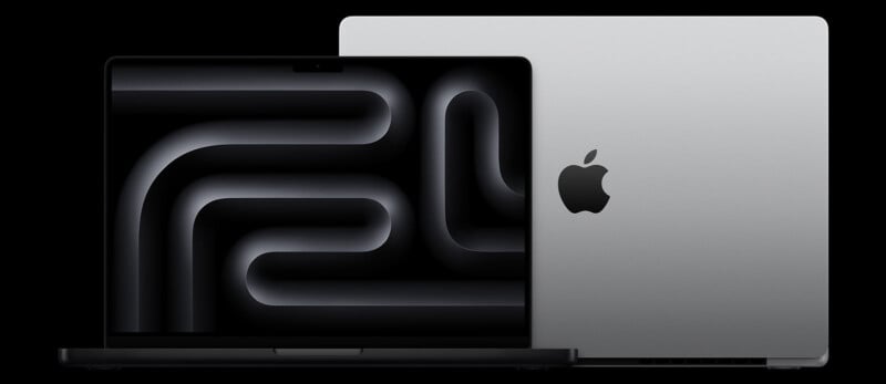 A sleek, silver laptop with an Apple logo is shown from the side and open, displaying a modern, abstract design on its screen. The image highlights the laptop's elegant design and minimalist aesthetics against a black background.