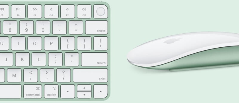 A close-up of a green keyboard and a white, sleek computer mouse on a light green background. The keyboard features standard keys and function buttons, and the mouse has an ergonomic, minimalistic design.