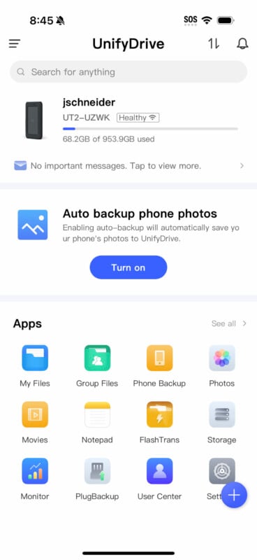 A screenshot of the UnifyDrive app interface. The top section shows device details with a health status and storage used. A notification about phone photo auto-backup option follows. Below that, app icons are displayed, including My Files, Group Files, and more.