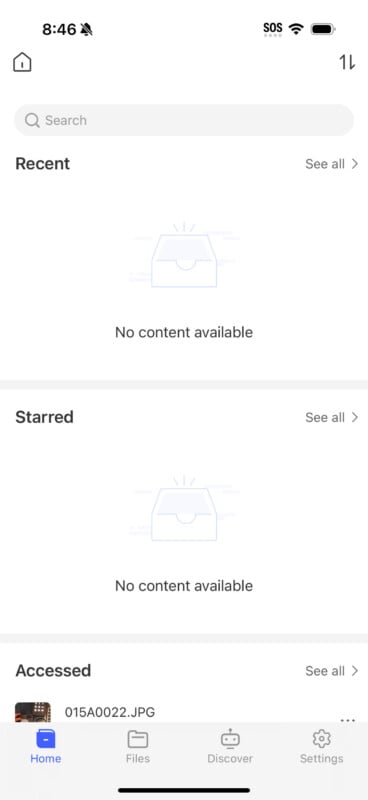 A mobile app screen displaying an interface for file management. The screen shows sections labeled "Recent" and "Starred" with "No content available" messages and a "See all" link. At the bottom, the "Accessed" section shows a file named "015A0022.JPG." The bottom navigation bar includes Home, Files, Discover, and Settings icons.