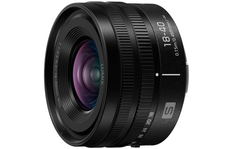 A black Panasonic Lumix S 18-40mm camera lens with multiple focus and zoom rings. The lens features focal length markings and a visible front glass element with a slight purple tint.