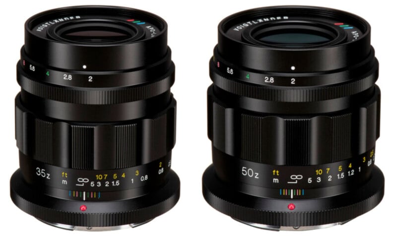 Two black Voigtländer camera lenses are shown side by side against a white background. The left lens is a 35mm focal length, while the right lens is a 50mm focal length. Both lenses have aperture markings and focusing scales in colorful detailing.