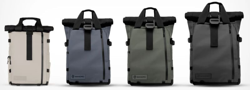 Four roll-top backpacks in various colors (light beige, blue, green, and black) are lined up against a white background. Each backpack features a front zipper pocket and buckle closure.