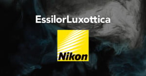 Graphic featuring the text "EssilorLuxottica" at the top. Below, a yellow logo with diagonal stripes and the text "Nikon" is displayed. The background consists of swirling dark and light patterns.