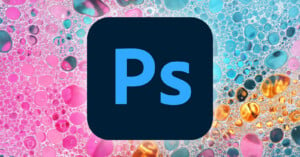 Photoshop logo centered on a vibrant, abstract background with pink, blue, and orange hues and bubble-like patterns.