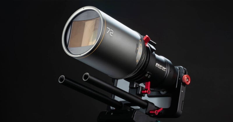 A professional camera lens mounted on a matte box with two rods for stabilization. The lens has a prominent "72" marking and features various dials and red accents for adjustments, set against a dark background.