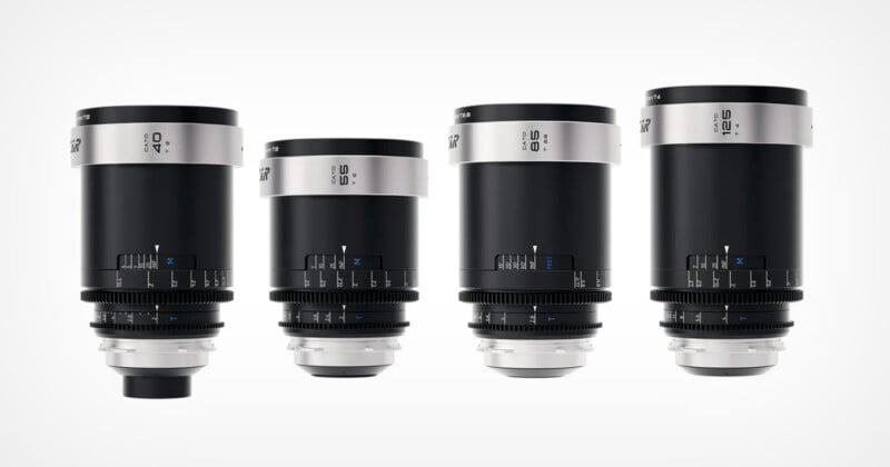 Four black and silver camera lenses of different focal lengths are arranged side by side against a white background. Each lens features blue focus and aperture markings.