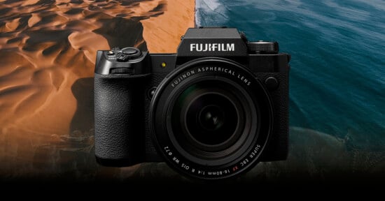 A Fujifilm camera with a Fujinon aspherical lens is displayed against a scenic background of sandy dunes meeting the ocean.