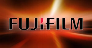 Fujifilm logo on a dynamic red and orange abstract background with light streaks.