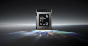 A Lexar Professional 1TB memory card is centered on a dark, reflective surface, illuminated by a prism effect of light below. The card displays specifications like 3700 MB/s read speed and 3400 MB/s write speed.