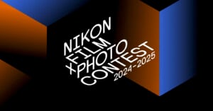 Stylized text on a geometric background reads "Nikon Film Photo Contest 2024-2025." The text is white and slanted, over a design featuring blue and orange blocks against a black backdrop.