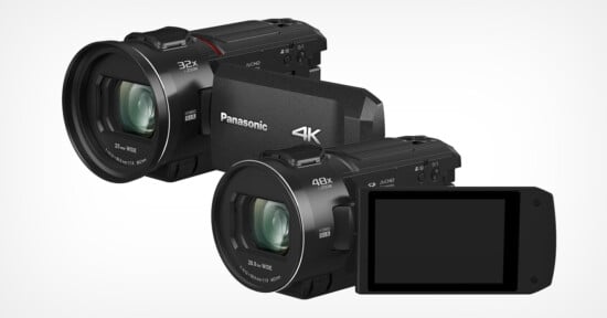 Two black Panasonic 4K camcorders are displayed. One shows the lens with "32x" and "25.0 wide" labeled, while the other shows "48x" and "24.0 wide." The second camcorder features an open LCD screen.