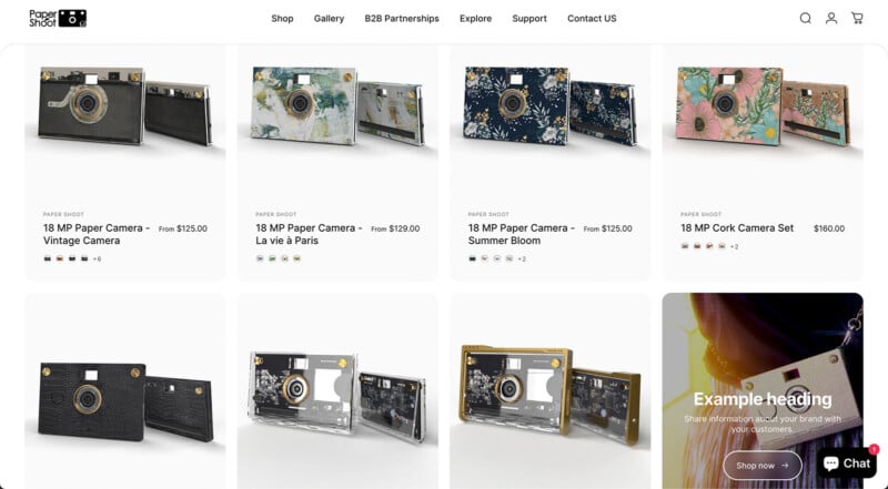 A website page displaying various 18 MP Paper Shoot cameras in different designs, such as vintage, floral, and clear cases. Each camera is priced from $125.00 to $180.00, with descriptions and options visible above a chat button at the bottom right.