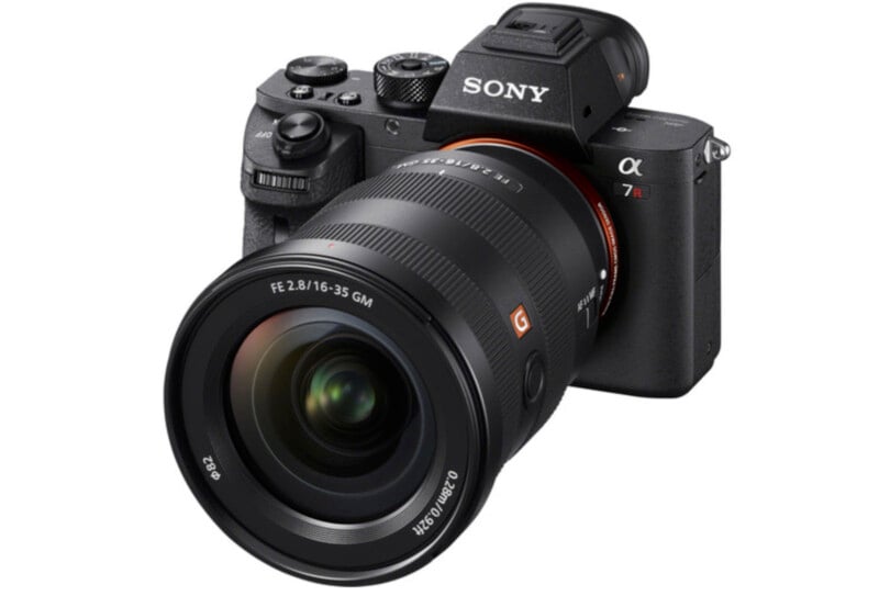 A black Sony Alpha camera with a large lens is angled to the right. The model "7R" is visible near the top. The lens has detailed labeling, including "FE 2.8/16-35 GM.