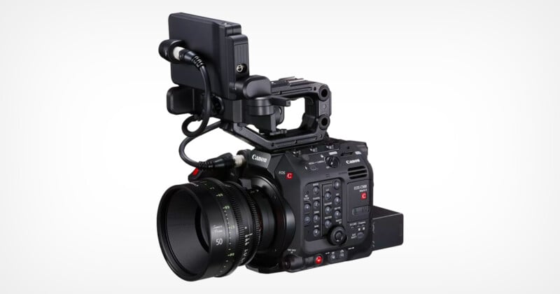 A Canon professional cinema camera with a large lens, mounted on a rig. It features various control buttons, a top handle, and an attached monitor. The camera is positioned against a plain white background.