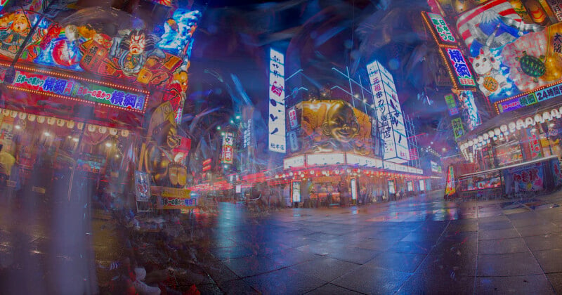 A vibrant, colorful street scene in a bustling urban area at night, filled with neon lights and illuminated signs. The buildings are adorned with various advertisements and whimsical, oversized decor. Wet pavement reflects the bright lights.