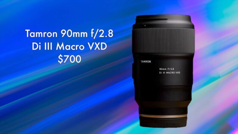 A Tamron 90mm f/2.8 Di III Macro VXD lens displayed on a vibrant blue and purple gradient background. The lens is priced at $700.