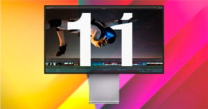 A large number "11" is displayed on a computer monitor with an image of a skydiver in the background. The colorful gradient backdrop includes shades of yellow, orange, and pink.