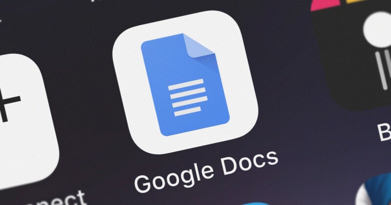 Close-up of the Google Docs app icon on a screen. The icon is blue with a white sheet of paper and three horizontal lines, representing text, in its center. The words "Google Docs" are visible below the icon.