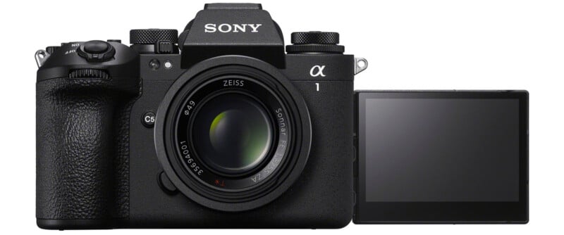 A Sony Alpha 1 camera with a Zeiss lens, featuring a flip-out LCD screen. The camera is shown from the front with the screen extended to the side.