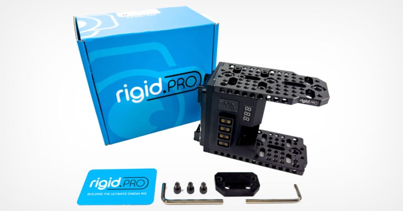 A blue box with "rigid.PRO" branding sits behind a camera rig setup, which includes mounting brackets and screws. Nearby are tools and a branded card. The background is white.