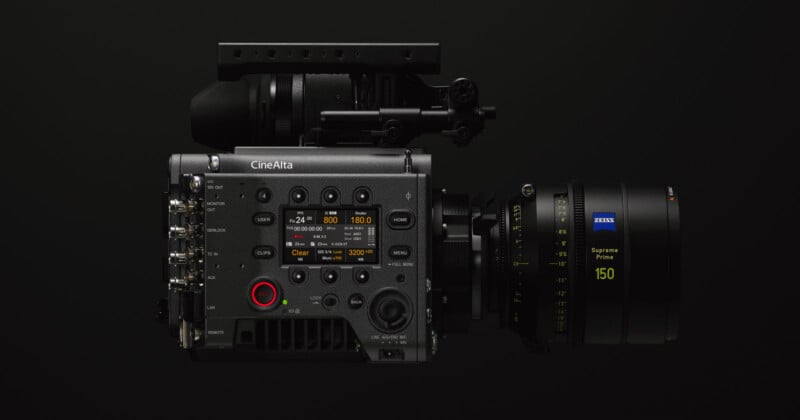 Side view of a professional CineAlta video camera with a large Zeiss Supreme Prime 150mm lens. The camera features multiple control buttons, switches, and connection ports, highlighted against a dark background.