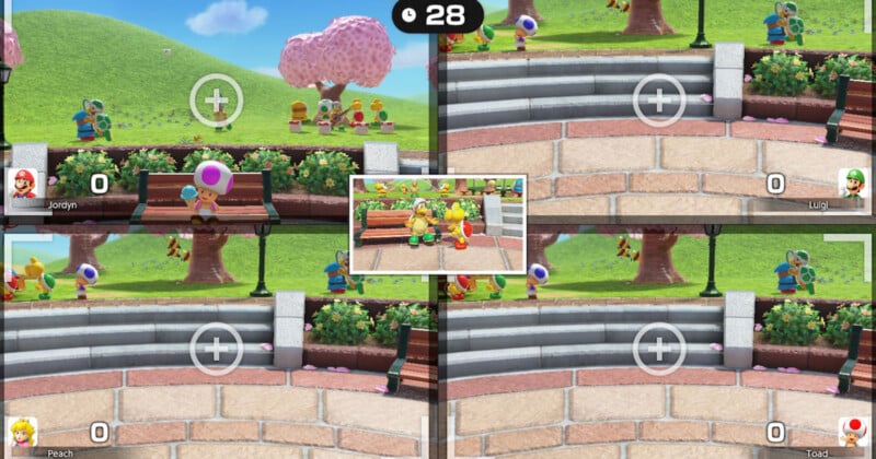 A split-screen video game image showing four players capturing a photo of a park scene with characters. The top view includes trees and pathways, while the center screen shows characters sitting on a bench. A countdown timer displays 28 seconds.