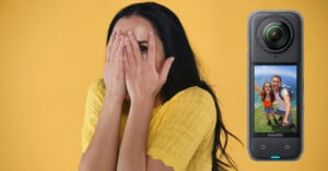 A woman in a yellow shirt playfully covers her face with her hands against a yellow background. Next to her is a 360-degree camera displaying a screen with a smiling couple taking a selfie outdoors.