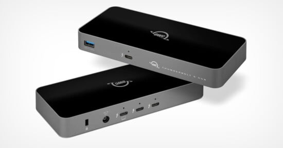 Two black rectangular electronic hubs with multiple ports are shown, including USB-C, HDMI, and audio jacks. The hubs have the "OWC" logo and are labeled "Thunderbolt 3 Hub." The background is light gray.