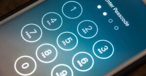 A close-up of a smartphone screen displaying a numeric keypad for entering a passcode. The screen shows numbers 0 to 9, with "Enter Passcode" at the top and four dots indicating passcode length.