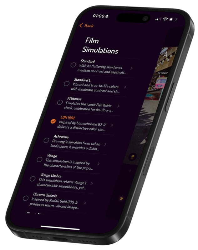 A smartphone screen displays a photography app's "Film Simulations" menu. Options include "Standard," "Achromia," and "Chroma Solaris," each with descriptions and selection circles. The time reads 01:06, with a simple interface in dark mode.